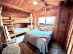 Bedroom 2 with queen bed, twin bunks, TV
